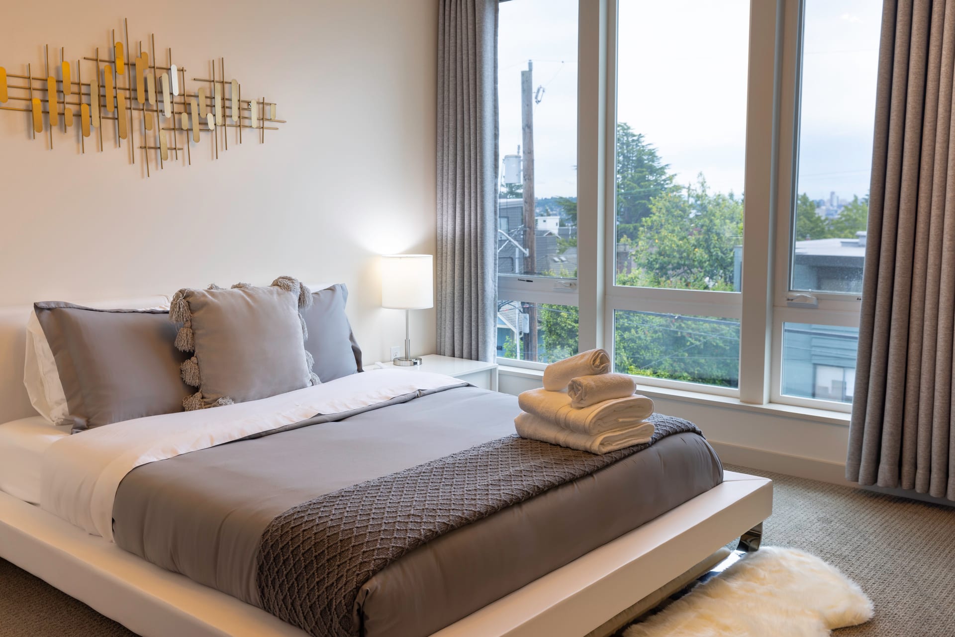 Primary bedroom with queen bed and motorized shades